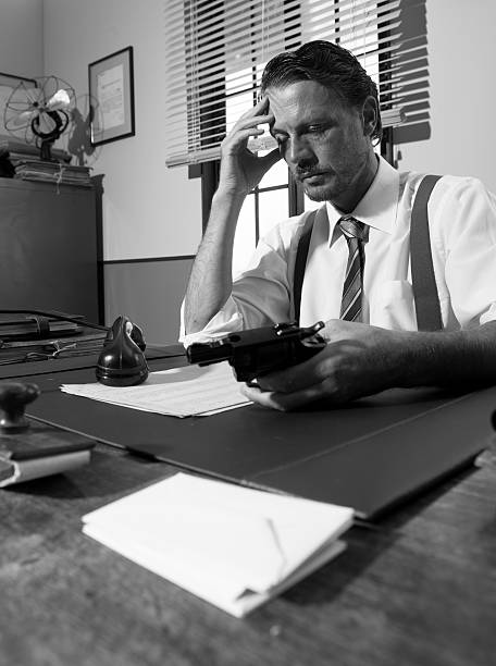 istock Depressed businessman with gun 487410062