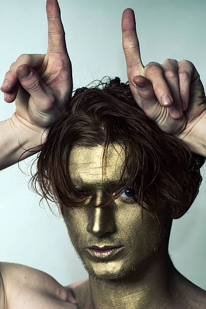 istock Golden man with hands as antlers 487411358