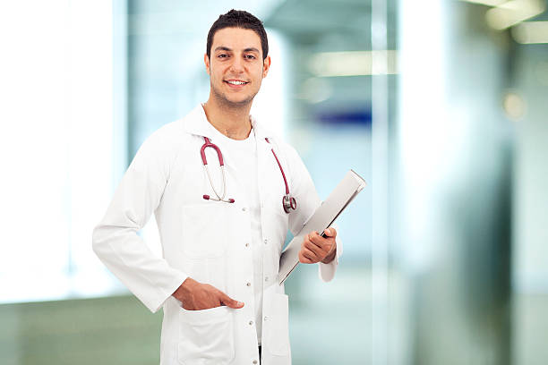 istock Young doctor man standing in hospital 487412224