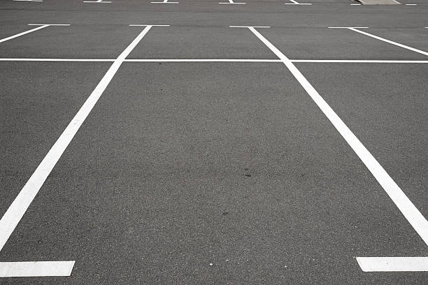 istock Empty parking place with white marking lines on asphalt 487412260