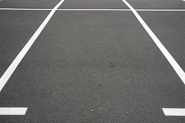 istock Empty parking place with white marking lines on asphalt 487412268