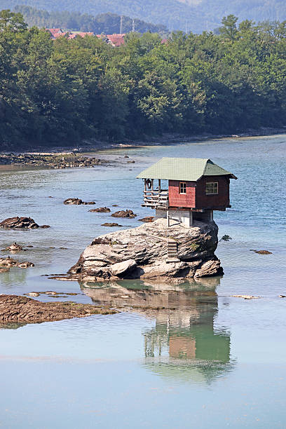 istock house on rock Drina river Serbia 487417074