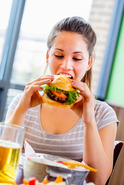 istock Young Woman and Burger 487417447