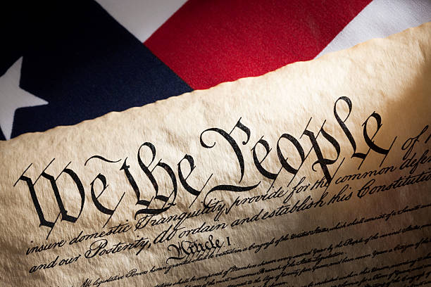 istock U.S. Constitution and American Flag 487417553