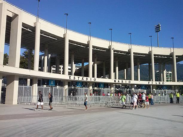 Main entrance of the Maracana stadium on game day Rio de Janeiro, Brazil - April 06, 2014: Soccer fans arrive at the Maracana stadium to watch one of the final games the state of Rio de Janeiro, Brazil, between Flamengo and Vasco da Gama. In the photo, the main entrance of the stadium. maracanã stadium stock pictures, royalty-free photos & images