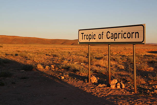 Namibia: Tropic Of Capricorn sign Walvis Bay, Namibia - March 17, 2012: A sign indicating the position of the Tropic Of Capricorn in the Namib-Naukluft National Park in Namibia. tropic of capricorn stock pictures, royalty-free photos & images