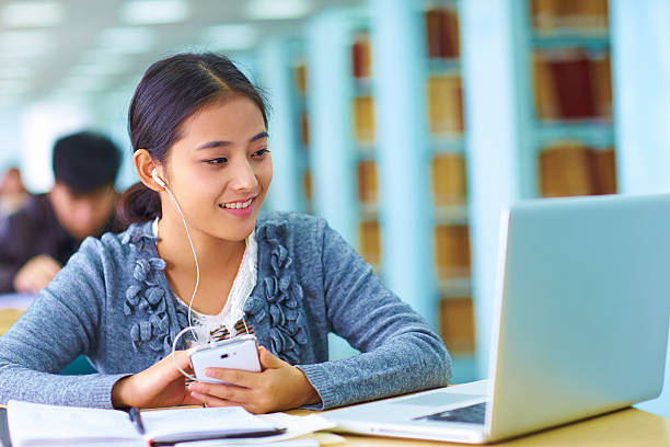 istock pretty asian college student in the library 487418527