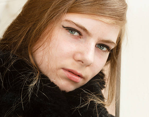 istock Blonde woman with stunning blue eyes looking at camera 487419752
