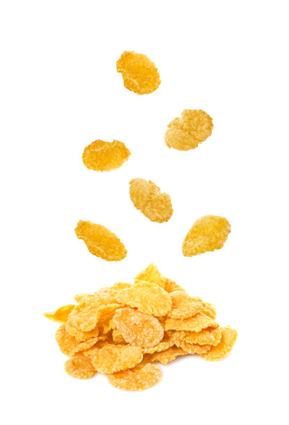 falling corn flakes isolated on white background falling corn flakes isolated on white background cornflakes stock pictures, royalty-free photos & images