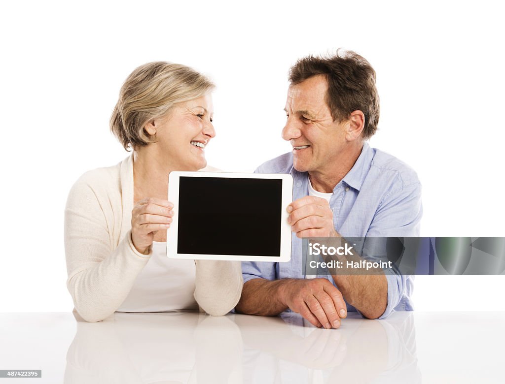 Senior couple with tablet Senior couple using tablet, isolated on white background 50-59 Years Stock Photo