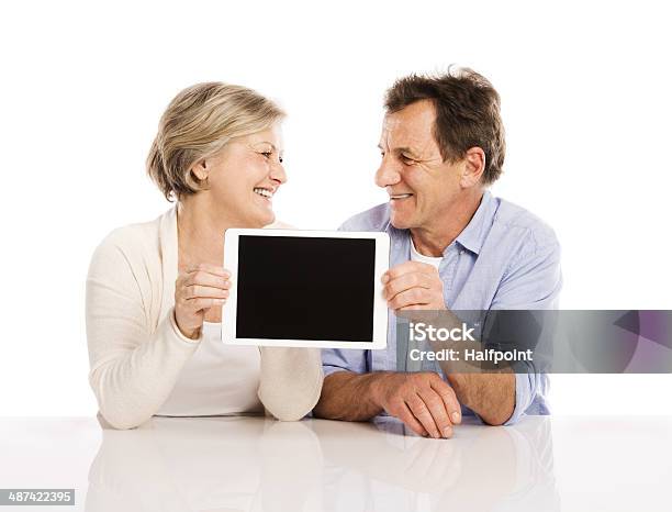 Senior Couple With Tablet Stock Photo - Download Image Now - 50-59 Years, 60-64 Years, 60-69 Years