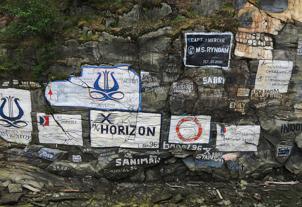 Skagway, Alaska, USA-June 18, 2012:  Ship Signature Wall is a rock decorated with painted  names of ships that have visited the port in Skagway since 1928.