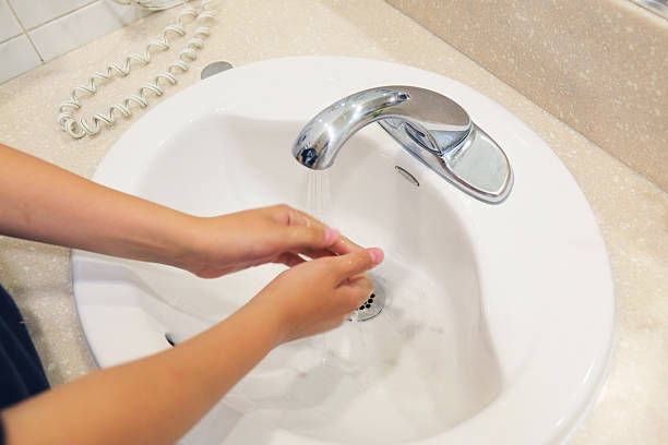 istock person washing hands in sink. 487423695