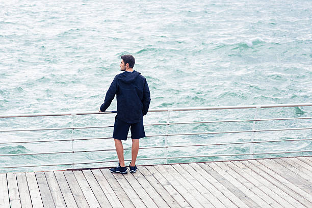istock Man looking at the sea outdoors 487423758