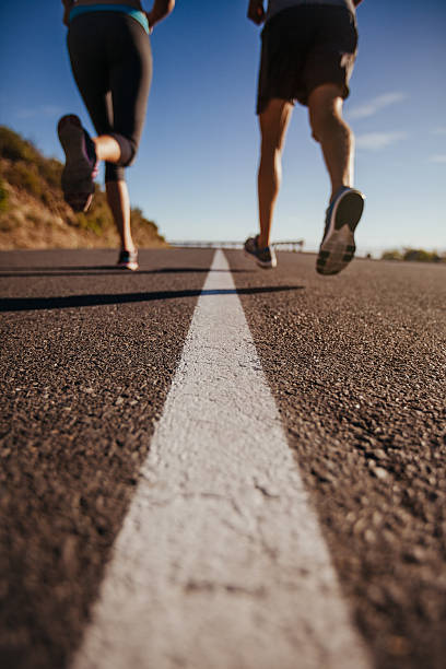 istock Athletes running on country road 487424406