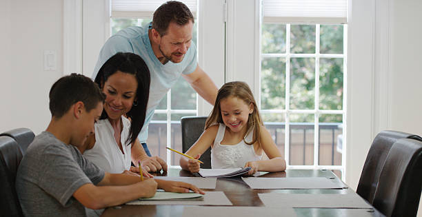 istock Parents Helping Children with Writing 487424522