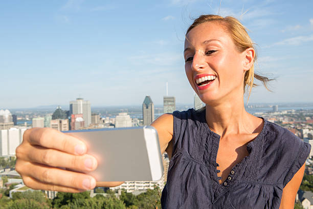 istock Student in Montreal taking selfie portrait with mobile phone 487425398