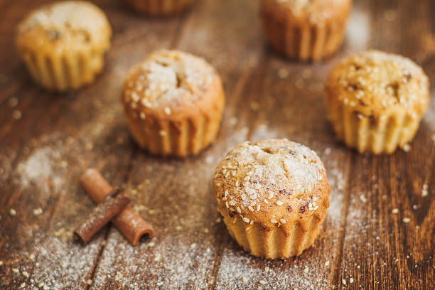 istock Light muffins with sesame on dark wooden background 487428100