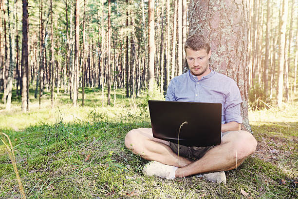 istock young man working with his laptop outdoors 487432418