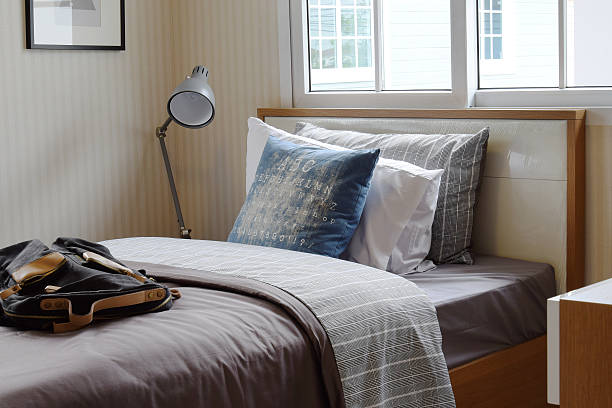 istock cozy bedroom interior with pillows and reading lamp 487432738