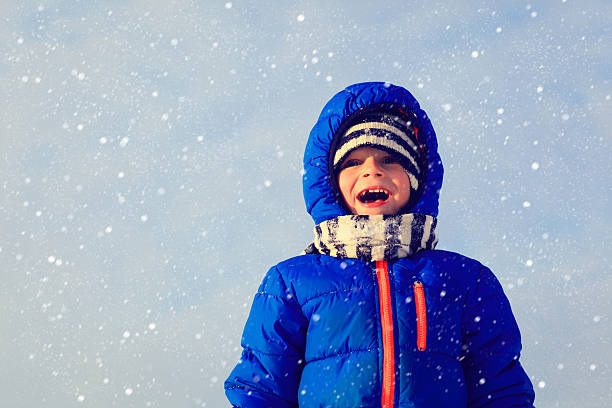 istock cute little boy enjoy snow in winter 487433060