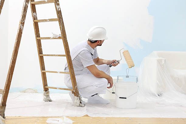 istock painter man at work takes the color with paint roller 487435744
