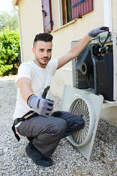 istock handsome young man electrician installing air conditioning in client house 487439640