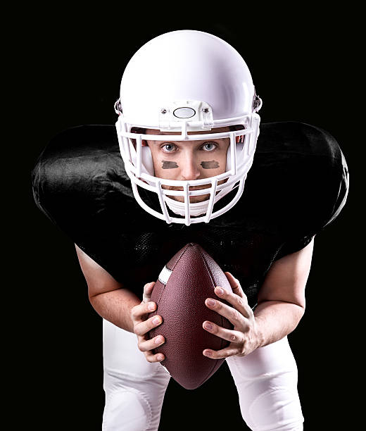istock Football Player on black uniform isolated on black background 487440140