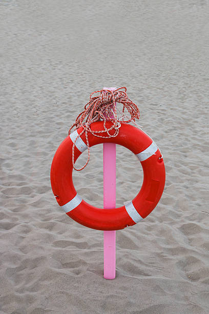 istock lifebuoy with a long rope hanging on a pink stake 487440634