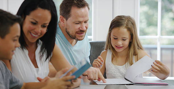 istock Parents Helping Children with Homework 487442518