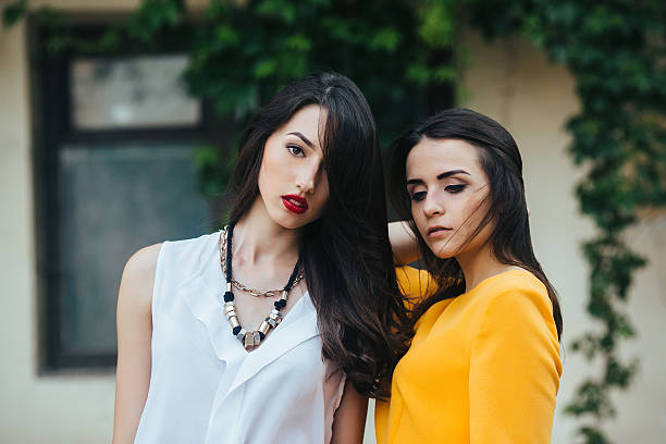 istock Two beautiful friends pose on white background 487443058