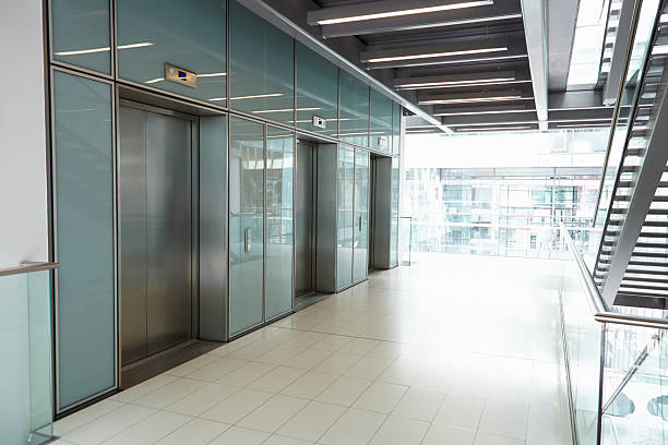 istock Elevators in the empty corridor of a corporate business 487443154