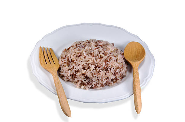 istock Brown rice dish cooked in white paint white background 487443638