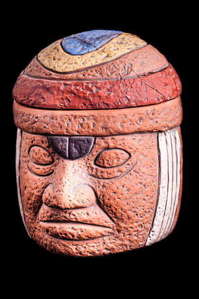 Olmec terracotta relic a terracotta olmec face idol souvenir isolated over a black background olmec head stock pictures, royalty-free photos & images