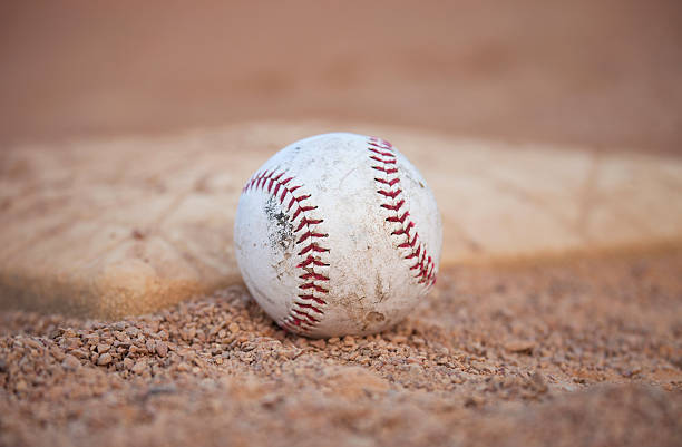 istock Selective focus low angle of grungy baseball and base 487443772