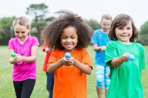 istock Multiracial group of children in an egg spoon race 487443782