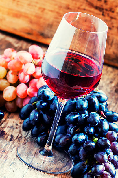 istock Red wine and blue and pink grapes 487444074