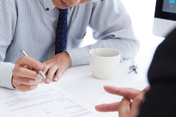 istock Discussion with a real estate agent at the office 487444366