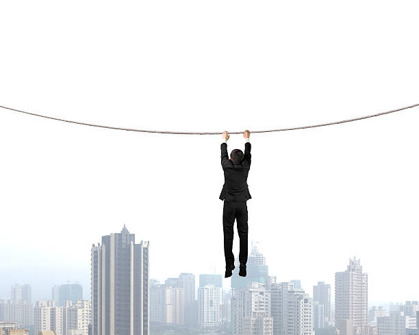istock Holding rope and hanging  with city view 487445385