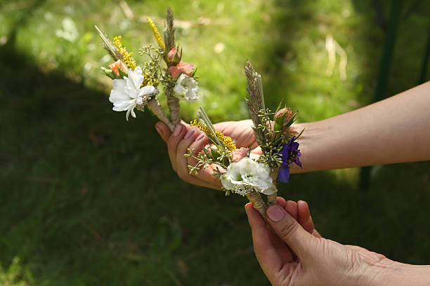 istock Forest Wedding Boutonnieres in hands 487445656