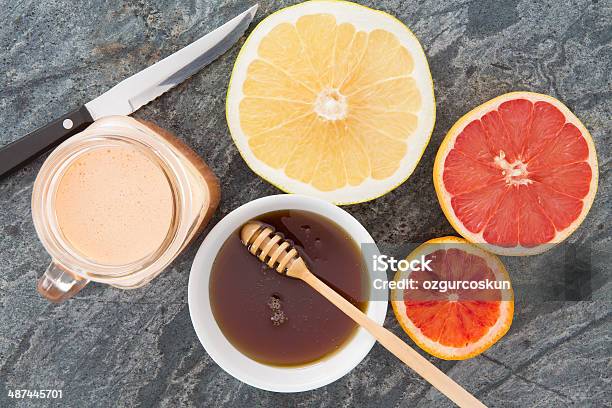 Fresh Grapefruit And Juice Served With Honey Stock Photo - Download Image Now - Acid, Breakfast, Citrus Fruit