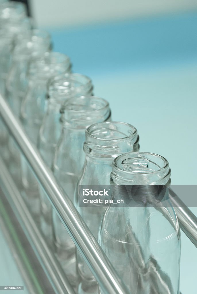 Glass bottles on the conveyor belt Food Processing Plant Stock Photo