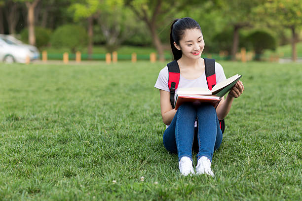 istock beautiful asian female student with backpack and notebooks 487446356