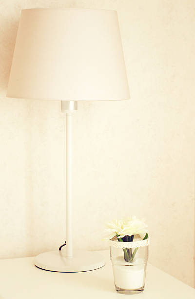 istock Lamp and flower on the table with retro effect 487446493