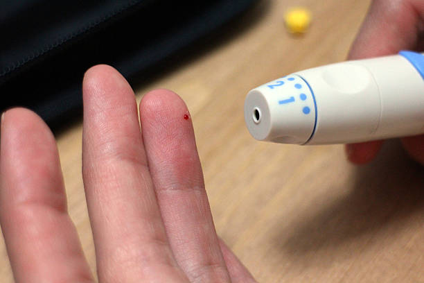 fingerprick - drop of insulin ストックフォトと画像