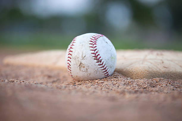 istock Selective focus low angle of grungy baseball and base 487448222