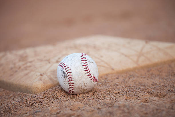 istock Selective focus low angle of grungy baseball and base 487448480