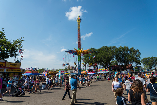 St. Paul, Minnesota, USA - September 4, 2015: High Flyer ride, vedors and game and crowds of People at the Midway section of the Minnesota State Fair, in St. Paul Minnesota.