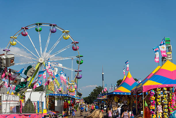 Rides, Games and Crowds of People at Minnesota State Fair St. Paul, Minnesota, USA. - September 4, 2015: Rides, Games and Crowds of People at the Midway section of the Minnesota State Fair, in St. Paul Minnesota midway fair stock pictures, royalty-free photos & images