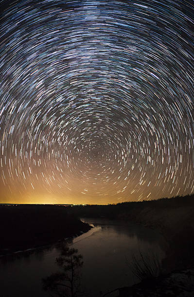 istock beautiful night sky, Milky Way, star trails  and trees 487451190